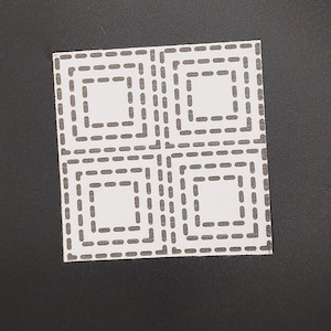 Square sashiko pattern of 4 concentric squares on white transfer on a black background.
