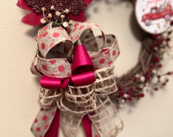May include: A fall-themed wreath with a burlap bow, red polka dot ribbon, and a red truck with the text "Pick Your Own Pumpkins".