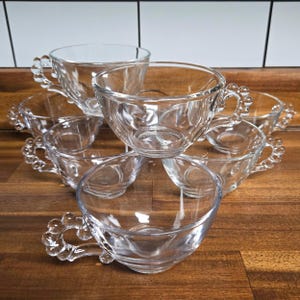 May include: A rustic wooden sign with the text "Welcome to our home" in white lettering. The sign features a distressed finish and a simple, inviting design, perfect for entryway decor.