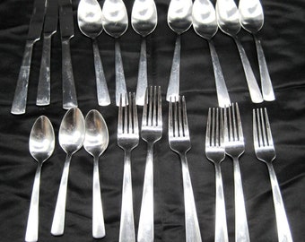 May include: A set of silverware, including forks, spoons, and knives, all made of polished stainless steel.