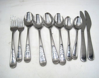 May include: A set of silverware, including forks, spoons, and knives, all made of stainless steel. The silverware has a simple, elegant design with a subtle swirl pattern on the handles.