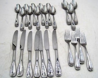 May include: A set of silverware, including forks, knives, and spoons, all made of stainless steel. The silverware is arranged in rows on a white surface.