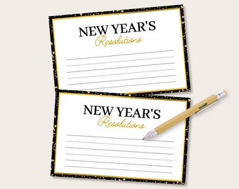 May include: Two blank white cards with black lines and gold glitter accents. The cards have the text "New Year's Resolutions" printed on them in black and gold.