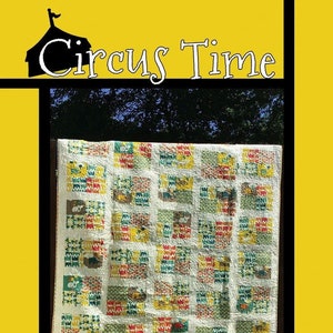 May include: A quilt pattern called "Circus Time" by Tricia Lynn Maloney for Villa Rosa Designs. The quilt is made of colorful squares with a variety of patterns and designs. The quilt is hanging on a wooden fence.