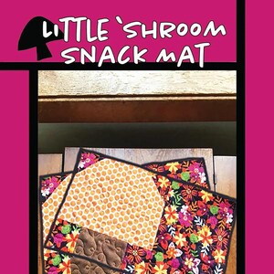 May include: Two quilted placemats with a mushroom design. The placemats are made of fabric with a floral pattern and a honeycomb pattern. The placemats are on a wooden surface. LITTLE 'SHROOM SNACK MAT. Tricia Lynn Maloney Orphan Quilt Designs for Villa Rosa Designs.