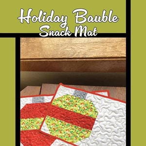 May include: Holiday Bauble Snack Mat. Two quilted snack mats with a bauble design. The baubles are red and green with white accents and a red border. The mats have a white background with a wavy pattern. The text "Holiday Bauble Snack Mat" is at the top.