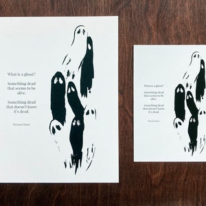 May include: Black and white print of a poem about ghosts with a black ink illustration of several ghosts. The poem reads "What is a ghost? Something dead that seems to be alive. Something dead that doesn't know it's dead. Richard Siken"