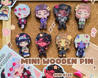 May include: A collection of mini wooden pins featuring characters from Baldur's Gate 3. The pins are approximately 4cm in size and have a spot gloss finish with a heart-shaped rubber back. The pins are displayed on a corkboard.