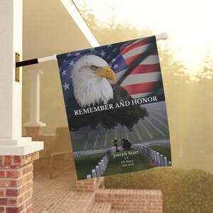 May include: A memorial flag with a bald eagle and an American flag in the background. The flag reads "Remember and Honor" and has a memorial inscription for Joseph Scott, LT, US Navy, 1990-2020.