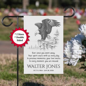 May include: A double-sided garden flag featuring a detailed black and white illustration of a bald eagle perched on a cliff. The flag includes a memorial message and the name "WALTER JONES" with dates.