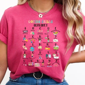 May include: Pink t-shirt with a colorful alphabet chart that lists coping skills for each letter. The chart is titled "Coping Skills Alphabet".
