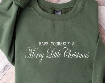 May include: A green sweatshirt with the text "Have Yourself a Merry Little Christmas" in white.