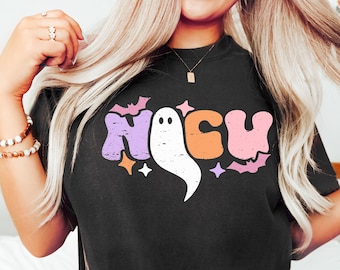 May include: Black t-shirt with a graphic of the word "Boo" in colorful, retro-style letters with a ghost in the middle. The letters have a distressed look.