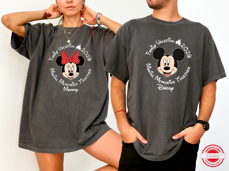 A woman and a man wearing matching t-shirts with a Mickey Mouse design pose together.