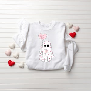May include: White sweatshirt with a pink ghost holding a pink heart balloon that says "Be My Boo".