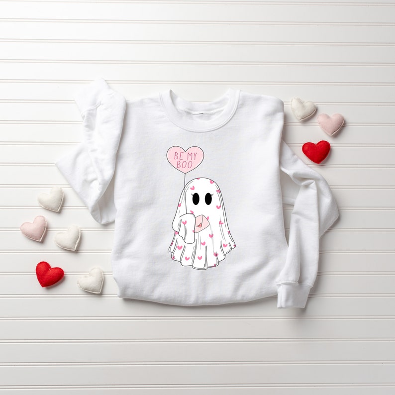 May include: White sweatshirt with a pink ghost holding a pink heart balloon that says "Be My Boo".