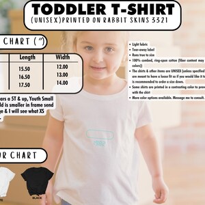 May include: Size chart for a toddler t-shirt printed on rabbit skins. The chart shows sizes 2T, 3T, and 4T with corresponding length and width measurements in inches. The t-shirt is available in white and black.