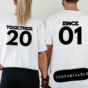 May include: Two white t-shirts with black text. One shirt says "Together 20" and the other says "Since 01" with a customizable area below the text.
