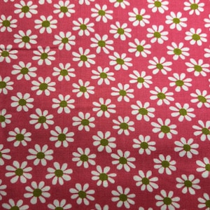 May include: Pink fabric with a white daisy pattern. The daisies have green centers.