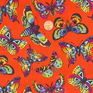 May include: Orange fabric with a repeating pattern of colorful butterflies. The butterflies feature intricate designs with multiple colors, including yellow, blue, purple, and green. A penny is visible in the image for scale.