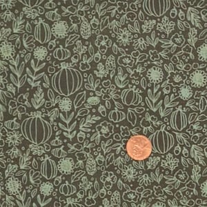May include: Dark brown fabric featuring a repeating pattern of pumpkins, flowers, and leaves in a light green hue. A penny is visible for scale. The design is a line drawing style, ideal for autumn-themed crafts and decorations.