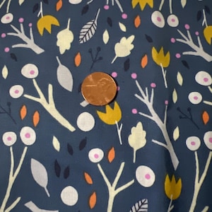 May include: A teal fabric with a repeating pattern of white branches, yellow flowers, orange leaves, and white circles with pink centers.