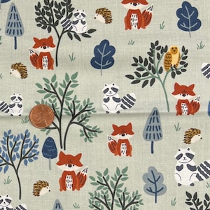 May include: A light green fabric featuring a repeating pattern of woodland creatures and trees. The design includes foxes, raccoons, hedgehogs, and owls in a whimsical forest scene. The trees are in shades of blue and green.
