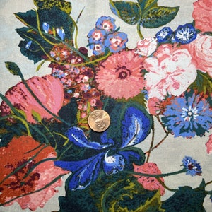 May include: A floral fabric with a light grey background featuring a large bouquet of pink, red, blue, and green flowers. The fabric has a vintage feel and would be perfect for crafting projects.