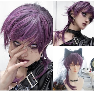 May include: A purple wig with a short, layered style and a long ponytail. The wig is styled in a modern, edgy fashion, with a dark root and lighter purple highlights. The wig is shown on a person with dramatic makeup and a black leather jacket.