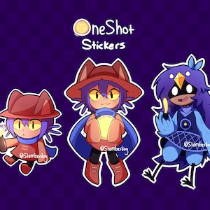 May include: Three colorful cartoon character stickers featuring characters from the video game "OneShot". The stickers are on a purple background with a checkered pattern. The text "OneShot Stickers" is at the top of the image.