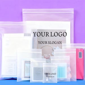 May include: A collection of translucent frosted plastic zipper bags in various sizes, featuring a white plastic slider closure at the top. Some bags display the printed black text YOUR LOGO and YOUR SLOGAN, while others contain various items.
