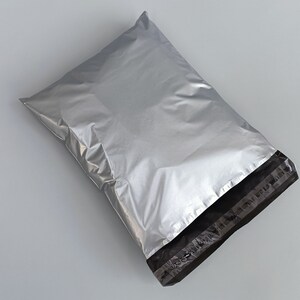 May include: A silver mailing envelope with a black seal strip. The envelope is made of a durable, waterproof material.
