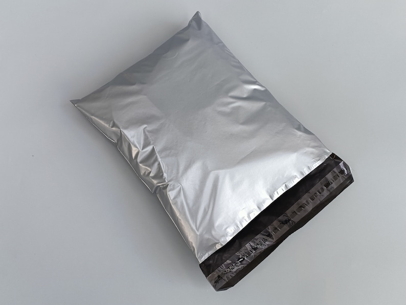 May include: A silver mailing envelope with a black seal strip. The envelope is made of a durable, waterproof material.