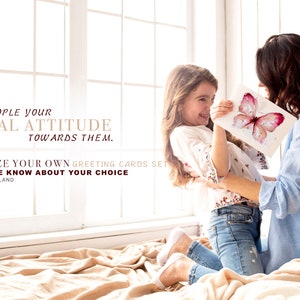 May include: A mother and daughter are sitting on a bed, smiling and holding a watercolour painting of a butterfly. The painting is on a white background with a pink butterfly. The text on the image reads: "Show people your special attitude towards them. Customize your own greeting cards set. Just let me know about your choice. www.marinart.land"