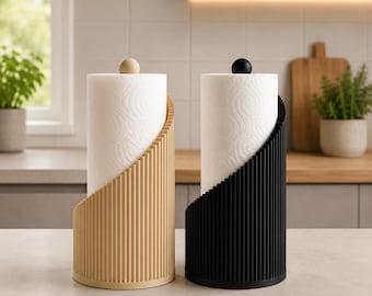 May include: Two cylindrical paper towel holders, one in light beige and one in black, each featuring a vertical ribbed texture and a small spherical finial on top. The holders are designed to store standard rolls of white paper towels.
