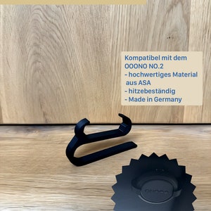 May include: Black Sonnenblendenhalter, a sun visor holder, with the text "Sonnenblendenhalter". The holder is compatible with OONO NO.2 and made of high-quality ASA material. The holder is heat resistant and made in Germany.