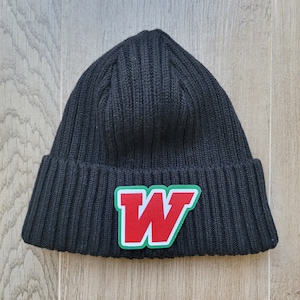 May include: Black knitted beanie with a red and green felt letter 'W' patch.