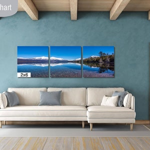 May include: A living room size chart showing a three-panel canvas print of a lake with snow-capped mountains in the background. The print is labeled "2x6" and is displayed above a white couch.