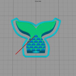 May include: A 3D printed mermaid tail cookie cutter with a teal blue outline and a green and blue tail. The tail has a scale pattern.