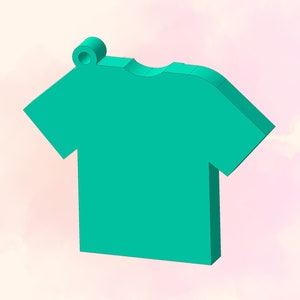 May include: A teal blue t-shirt shaped charm with a small ring at the top.