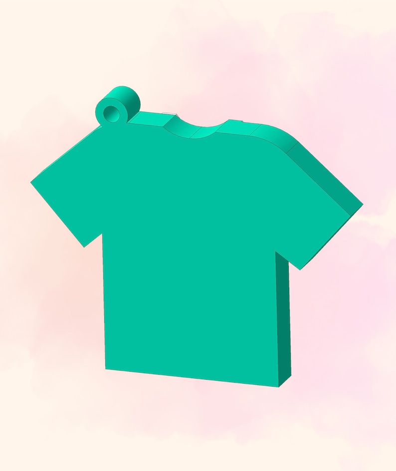 May include: A teal blue t-shirt shaped charm with a small ring at the top.