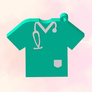 May include: A teal green scrub top with a white pocket and a white stethoscope outline. The scrub top has a loop at the top for hanging.