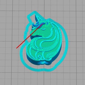 May include: A turquoise blue 3D printed unicorn cookie cutter with a detailed design. The unicorn has a horn, mane, and tail. The cookie cutter is ready to be used to create unicorn-shaped cookies.