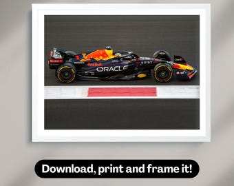 May include: A black and red Formula One race car with the words "Red Bull" and "Oracle" on the side. The car is on a race track with a red and white stripe.