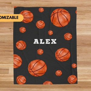 May include: Black and orange basketball themed fleece blanket with the name "ALEX" printed in white on the front.