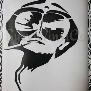 May include: Black and white silhouette of a person wearing sunglasses. The person is looking to the side and has a serious expression. The image is a simple, stylized design.