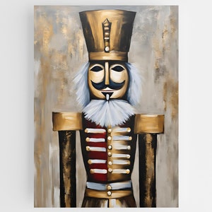 May include: A gold and red painted nutcracker with a white beard and moustache. The nutcracker is standing against a gold and grey background.