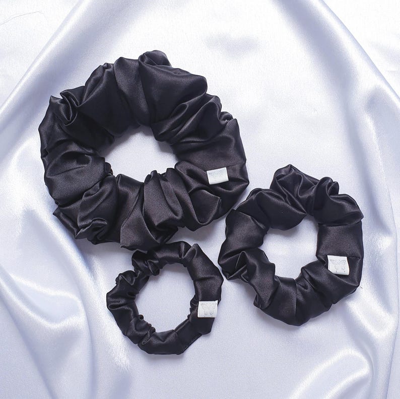 Black silky satin scrunchies available in 3 sizes:
Approximate Sizes:
XXL - 6 inches in diameter
Medium -4 inches in diameter
Mini - 3 inches in diameter
