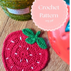 May include: Crochet pattern for a red strawberry with green leaves. The pattern is available in English and is a PDF download.