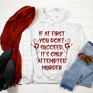 May include: White hooded sweatshirt with a red graphic print that says "If at first you don't succeed, it's only "attempted" murder". The graphic includes two bloody handprints.